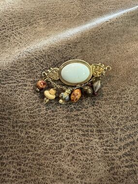 Gold-Tone Brooch with White Center Stone and Mixed Bead Charms